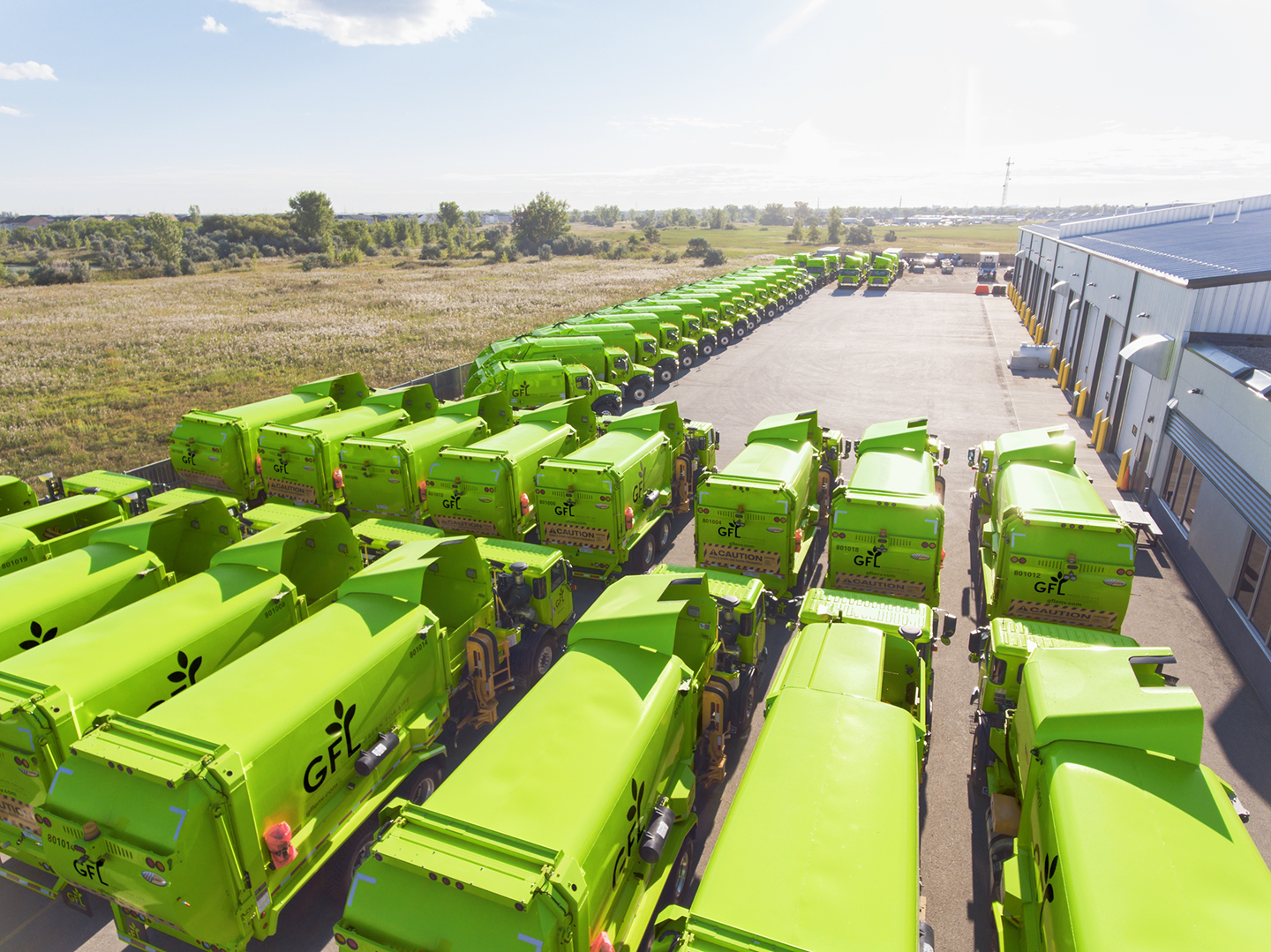 GFL trash trucks parked in a lot